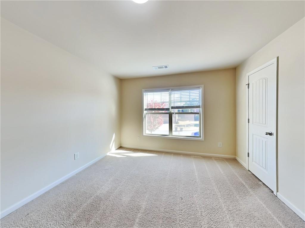 7770 Harbison Hollow Lane Suwanee, GA 30024 - Photo 13 of 25 a view of an empty room with a window