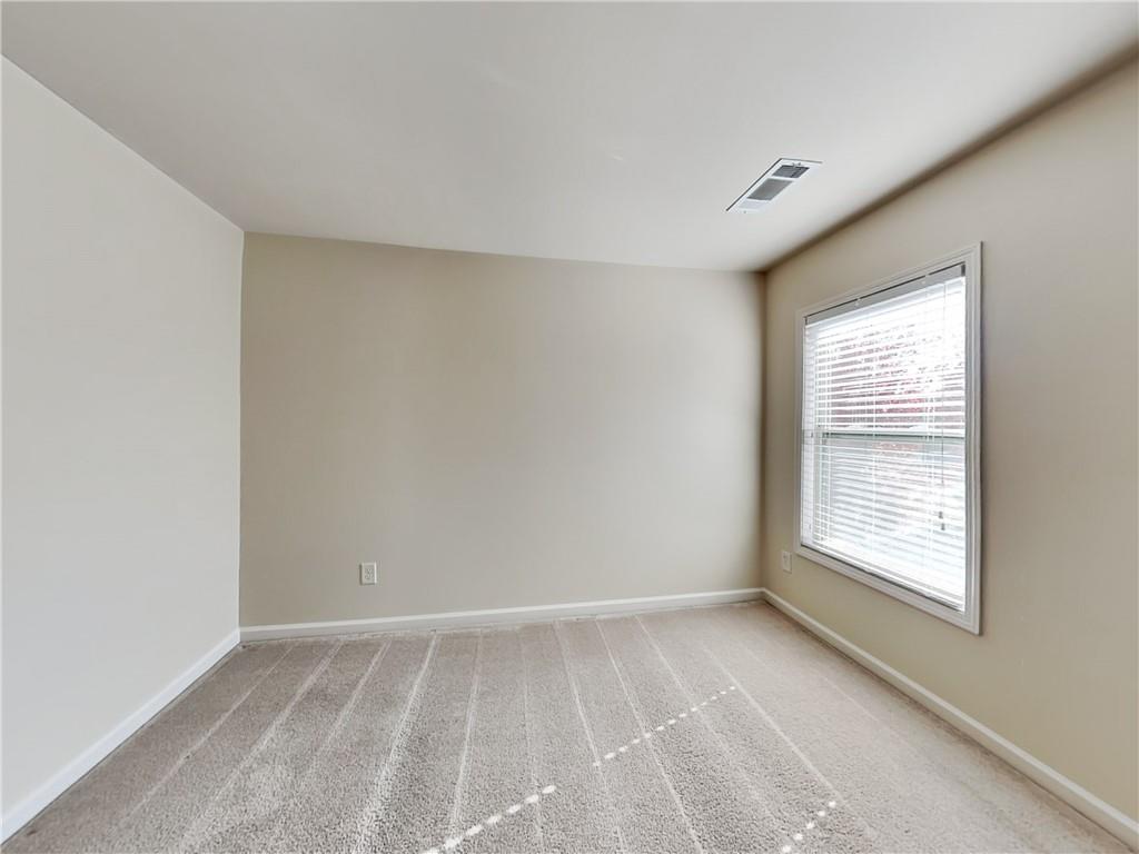 7770 Harbison Hollow Lane Suwanee, GA 30024 - Photo 15 of 25 a view of an empty room with a window