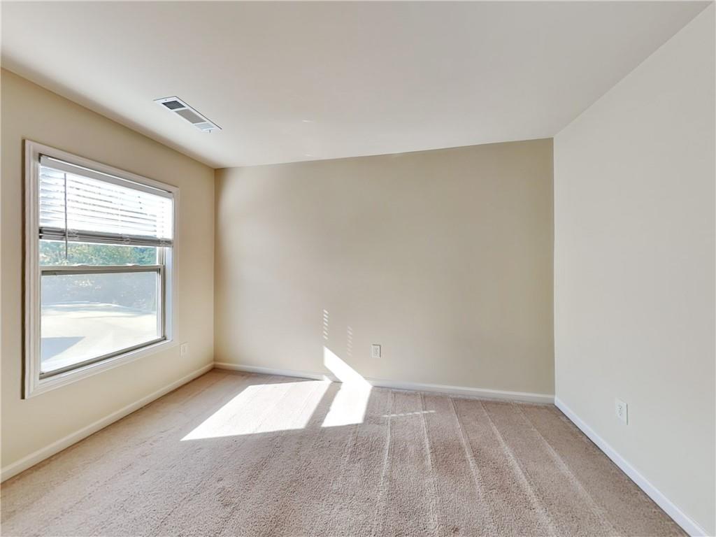 7770 Harbison Hollow Lane Suwanee, GA 30024 - Photo 16 of 25 an empty room with a window