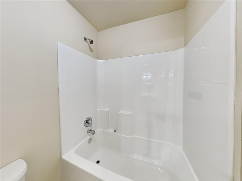 7770 Harbison Hollow Lane Suwanee, GA 30024 - Photo 19 of 25 a bathroom with a bathtub