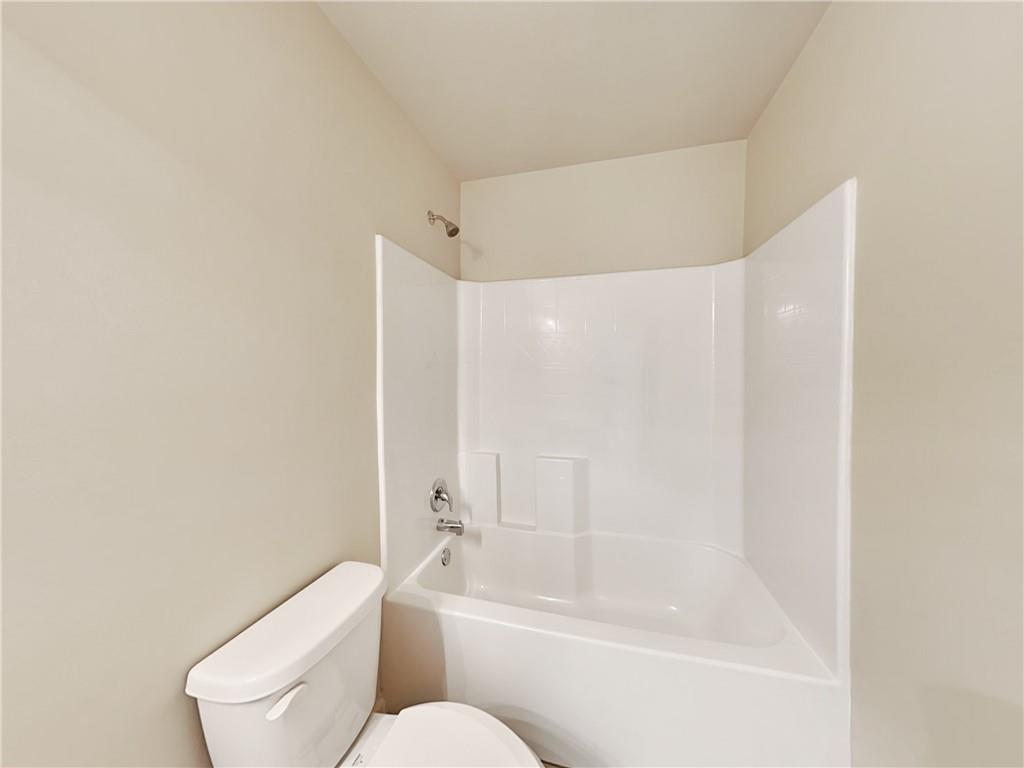 7770 Harbison Hollow Lane Suwanee, GA 30024 - Photo 20 of 25 a bathroom with a toilet and a bathtub