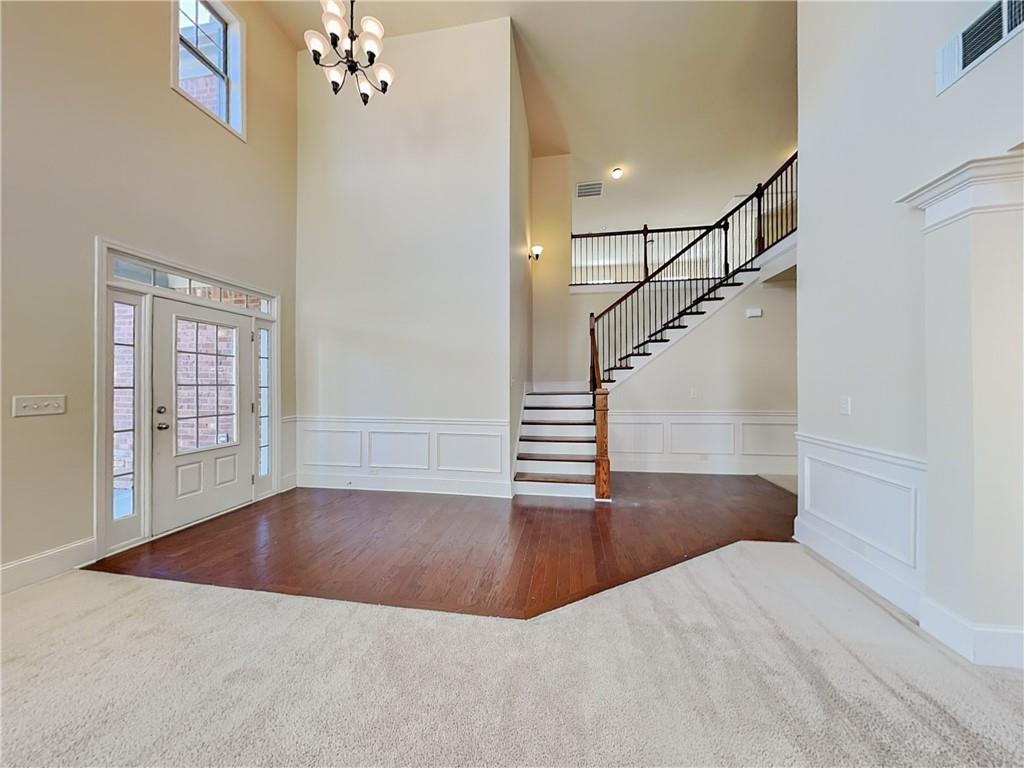 7770 Harbison Hollow Lane Suwanee, GA 30024 - Photo 2 of 25 a view of entryway and hall with wooden floor