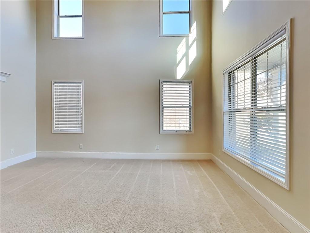 7770 Harbison Hollow Lane Suwanee, GA 30024 - Photo 4 of 25 an empty room with windows