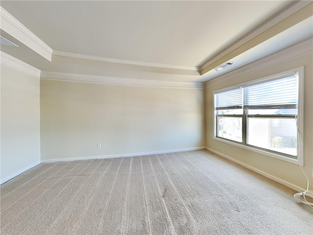 7770 Harbison Hollow Lane Suwanee, GA 30024 - Photo 8 of 25 an empty room with wooden floor and windows