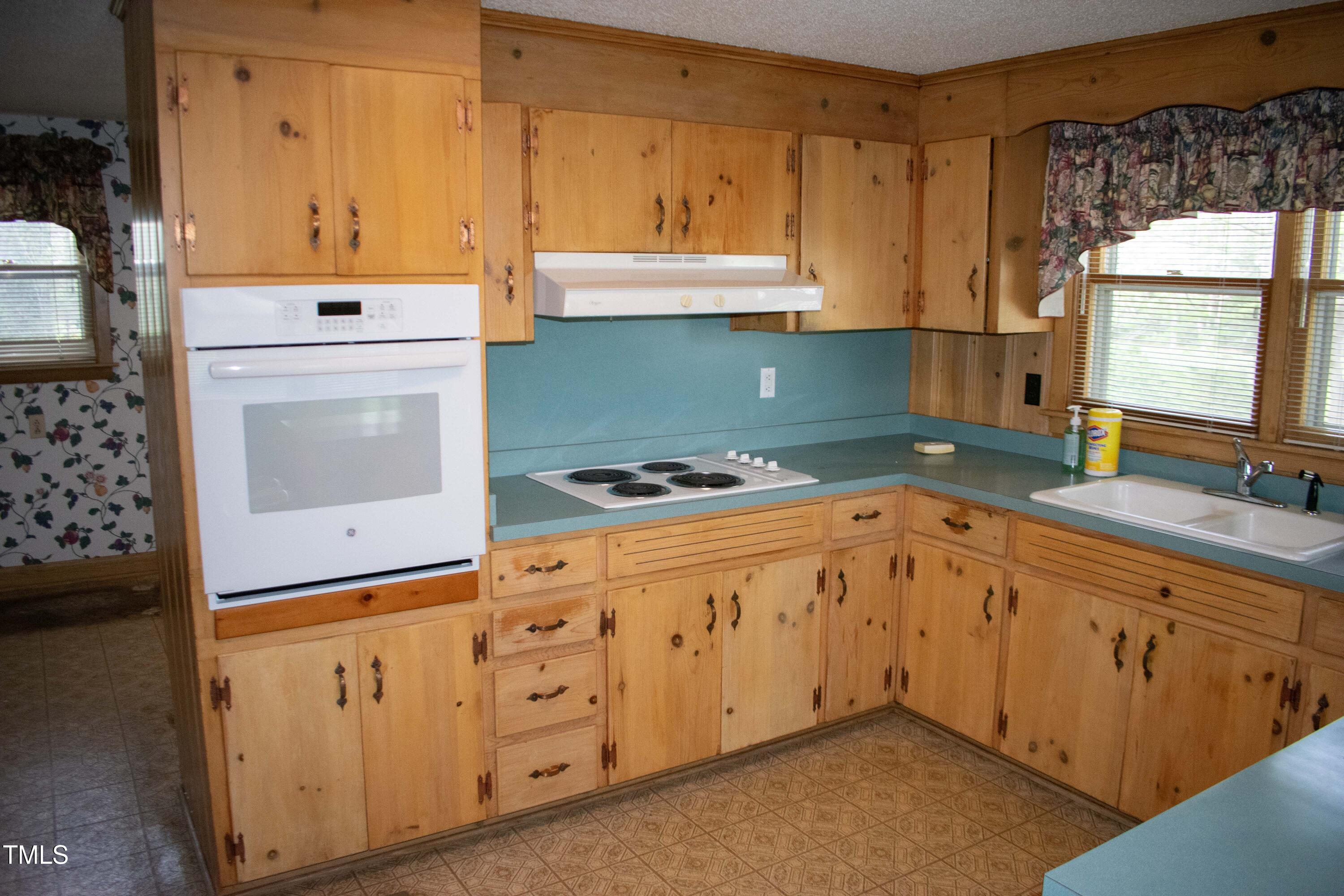 2024 Zebulon Road Zebulon, NC 27597 - Photo 16 of 16 a kitchen with granite countertop cabinets a sink a window and stainless steel appliances