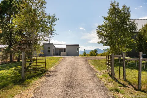 a view of a house with swimming pool and sitting area