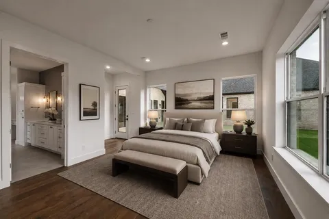 a view of an empty room with kitchen and window
