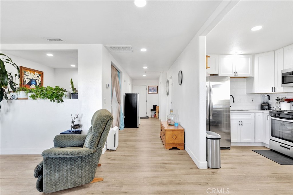 15109 Anacapa Road Victorville, CA 92392 - Photo 15 of 40 a living room with furniture and kitchen view
