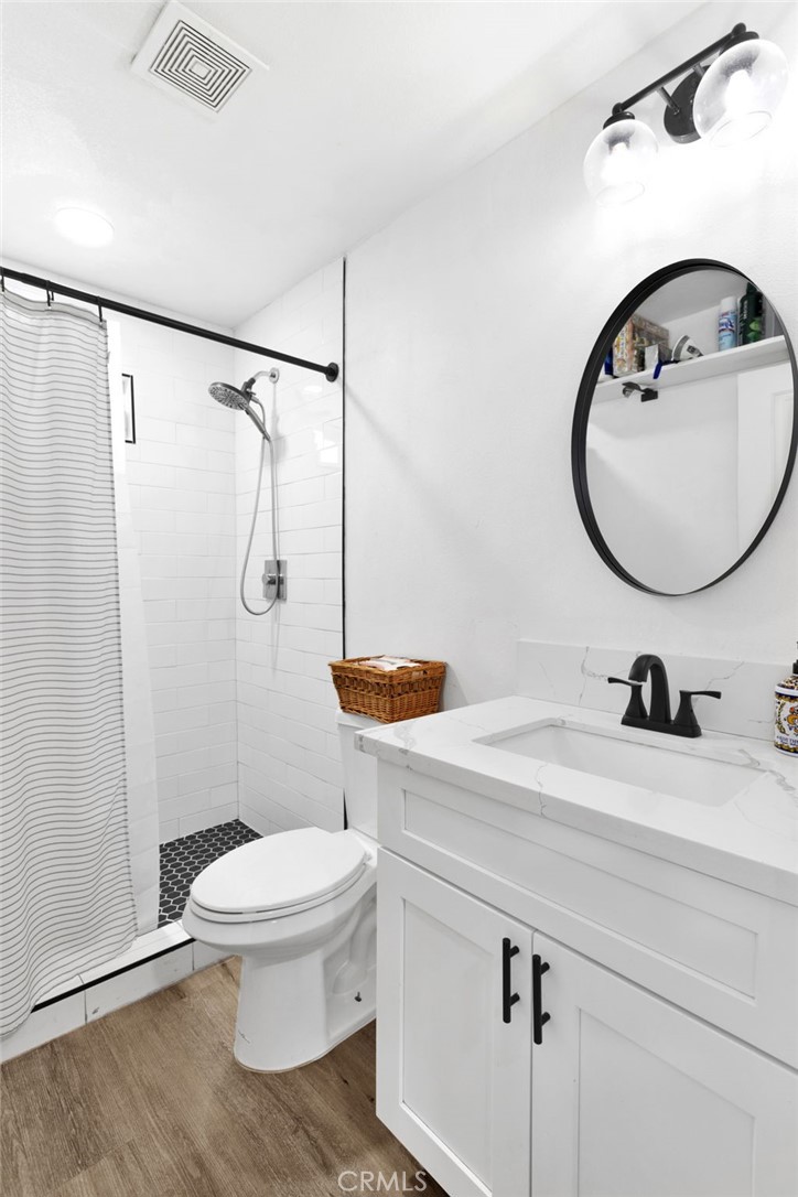 15109 Anacapa Road Victorville, CA 92392 - Photo 20 of 40 a bathroom with a sink a toilet and a mirror