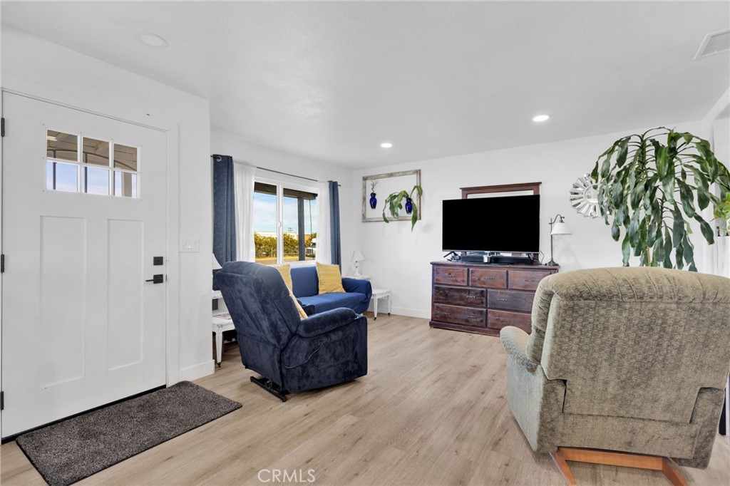 15109 Anacapa Road Victorville, CA 92392 - Photo 10 of 40 a living room with furniture and a flat screen tv