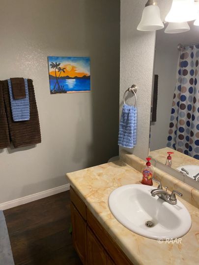 277 East Upjohn Avenue Ridgecrest, CA 93555 - Photo 16 of 20 a bathroom with a sink and a mirror