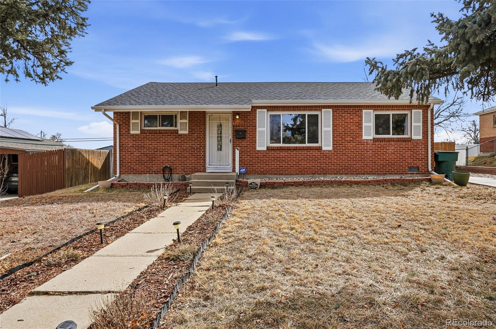 9280 Wigham Street Thornton, CO 80229 - Photo 1 of 34 a front view of a house with a yard