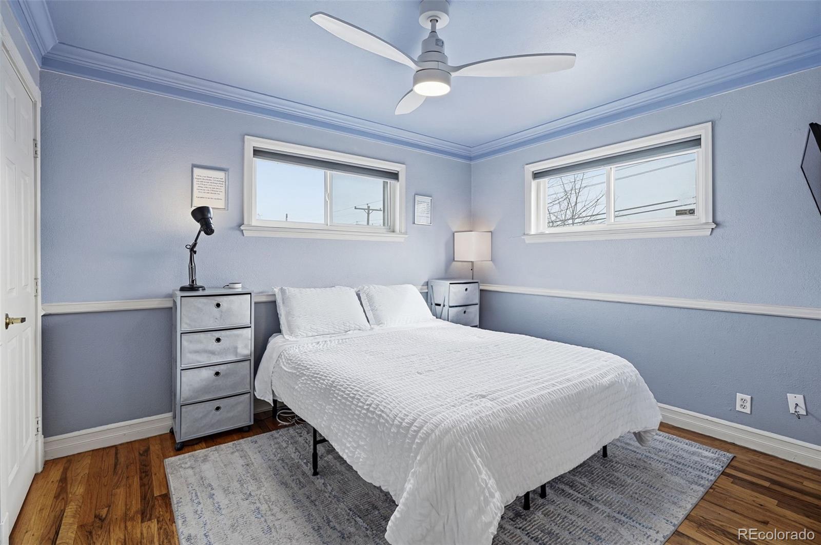 9280 Wigham Street Thornton, CO 80229 - Photo 15 of 34 a bedroom with a bed and a chandelier