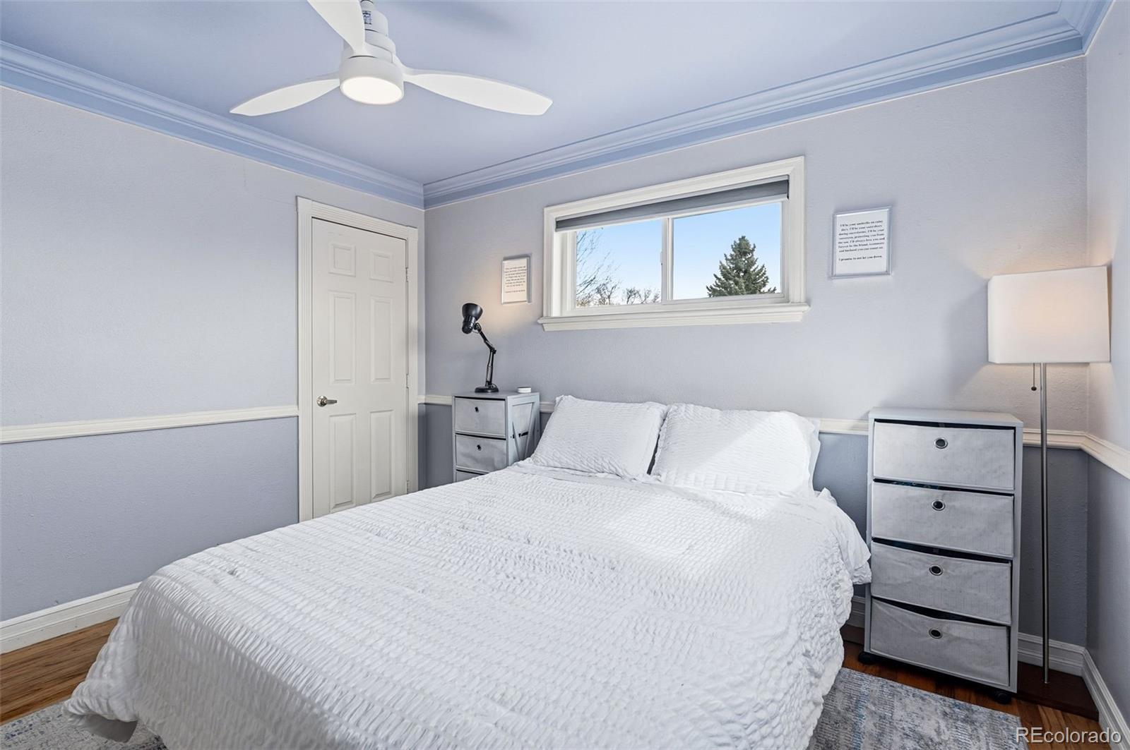 9280 Wigham Street Thornton, CO 80229 - Photo 16 of 34 a bedroom with a bed and a lamp on dresser