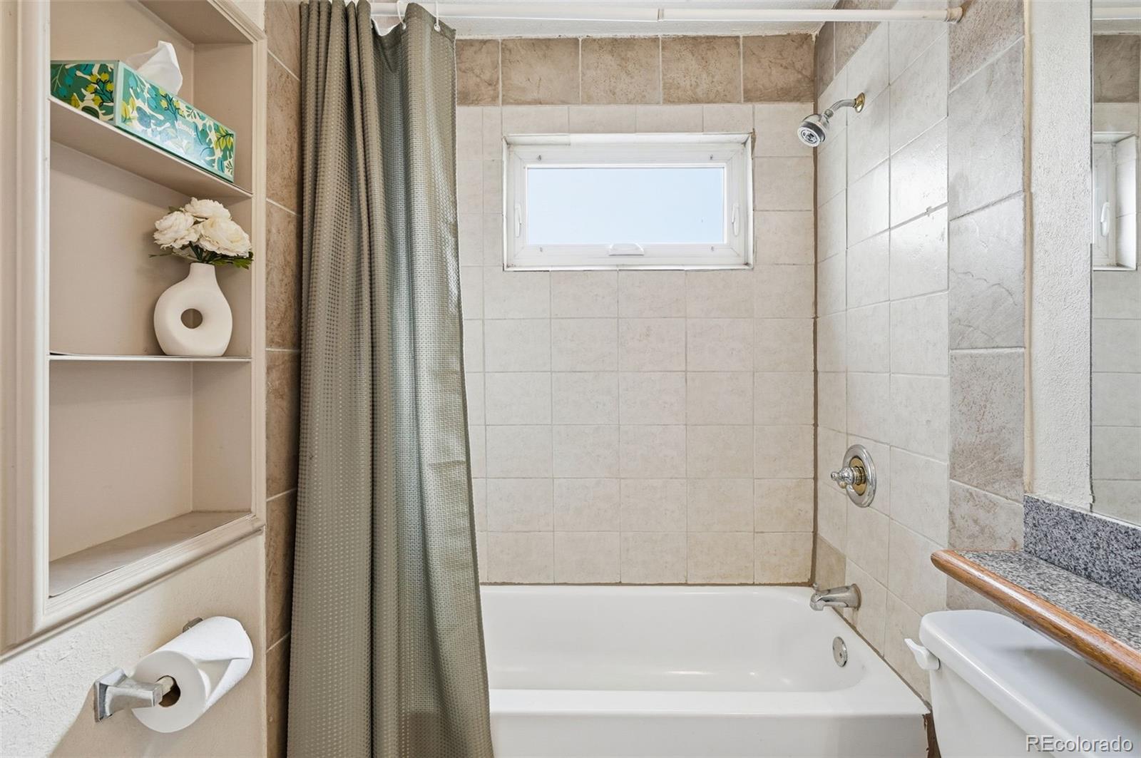 9280 Wigham Street Thornton, CO 80229 - Photo 19 of 34 a bathroom with a bathtub and a shower