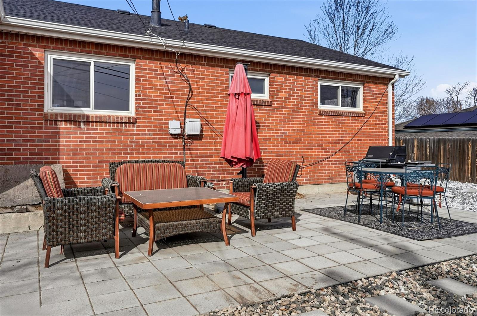 9280 Wigham Street Thornton, CO 80229 - Photo 27 of 34 a backyard of a house with barbeque oven table and chairs
