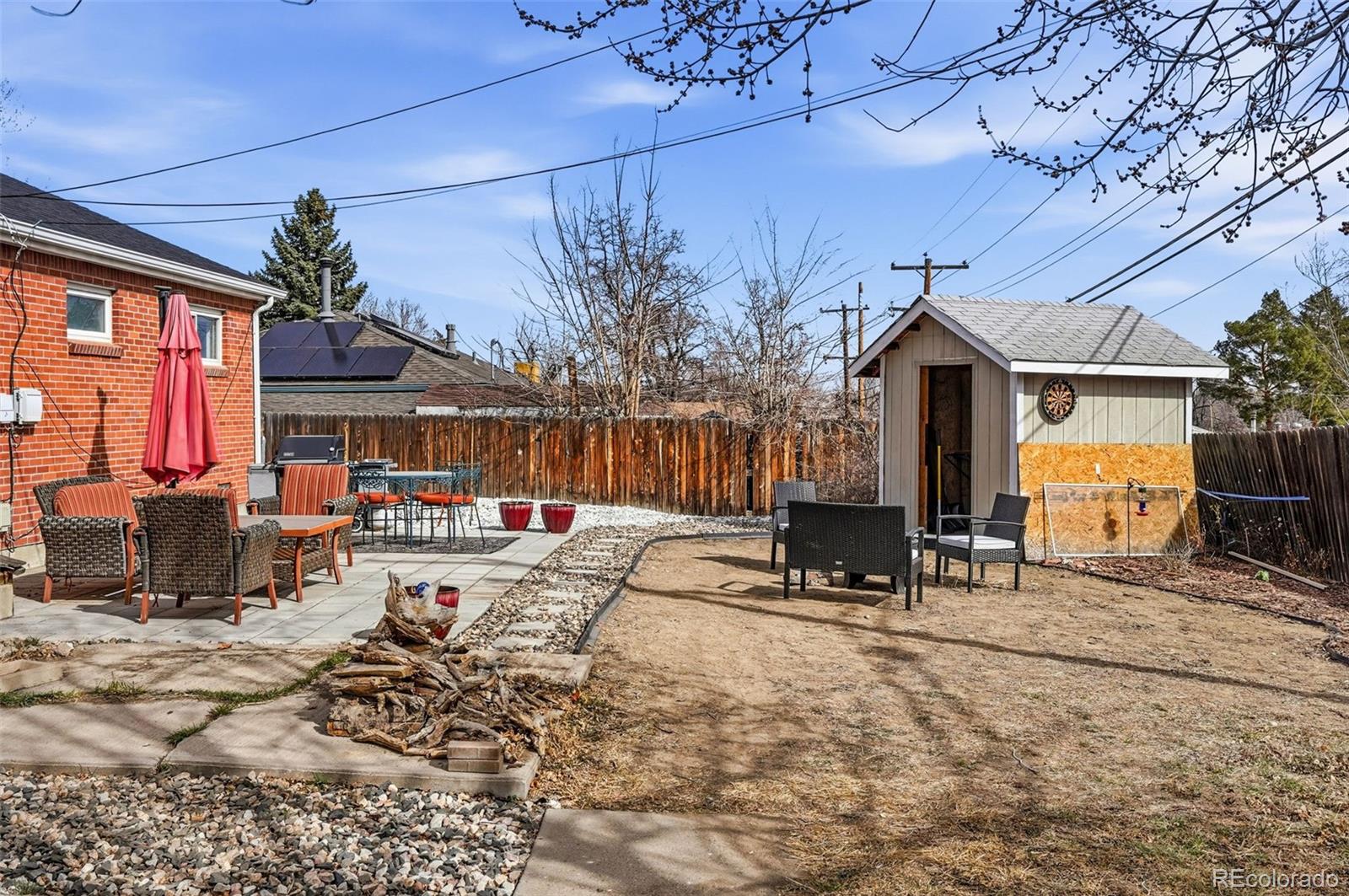9280 Wigham Street Thornton, CO 80229 - Photo 32 of 34 a view of a dinning tables and chairs in the patio in front of a house