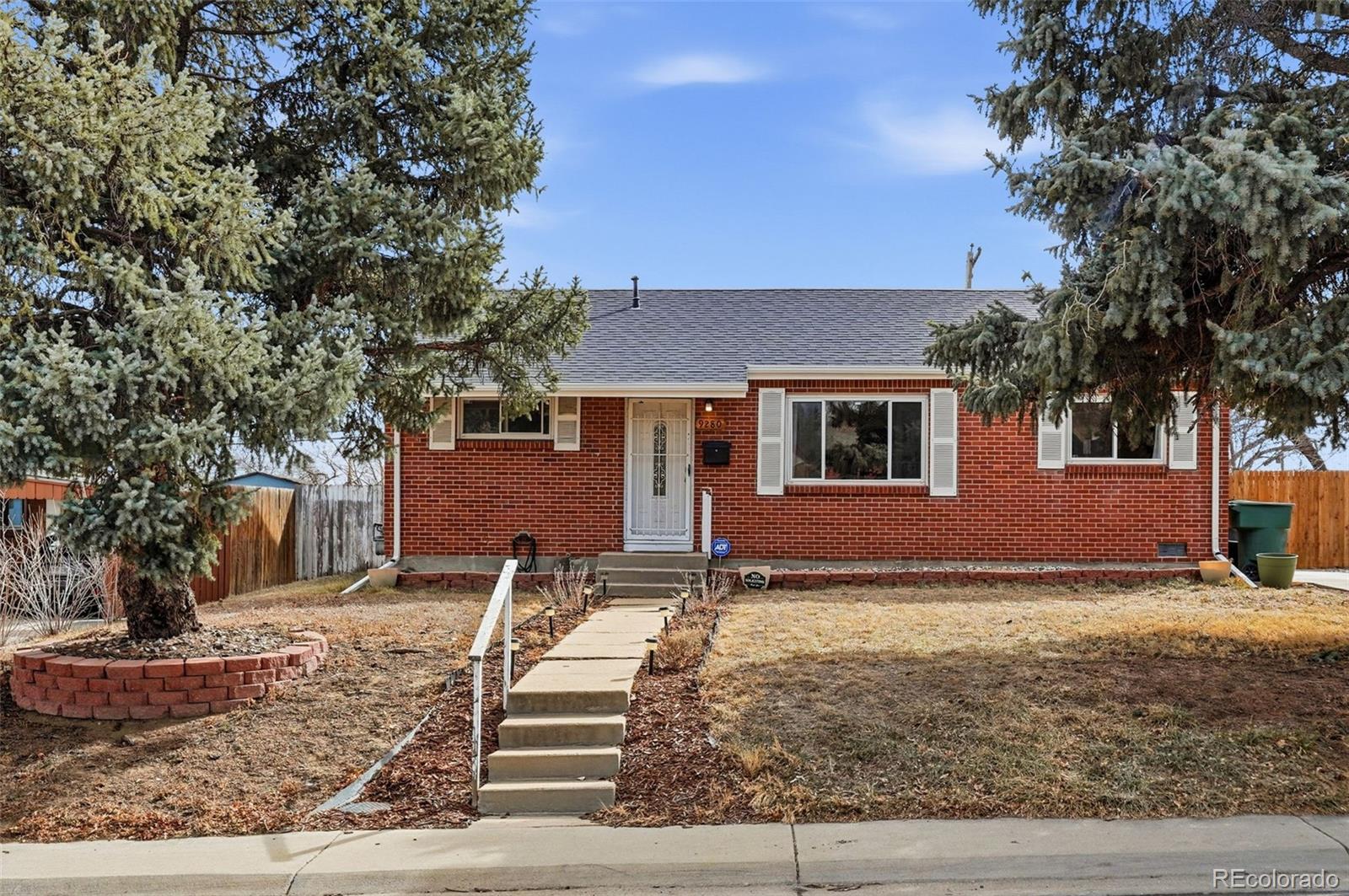 9280 Wigham Street Thornton, CO 80229 - Photo 33 of 34 a front view of a house with garden