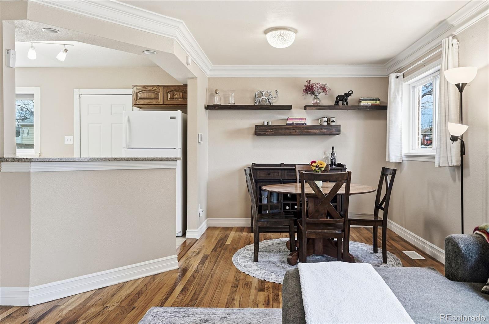 9280 Wigham Street Thornton, CO 80229 - Photo 7 of 34 a view of a dining room with furniture and wooden floor
