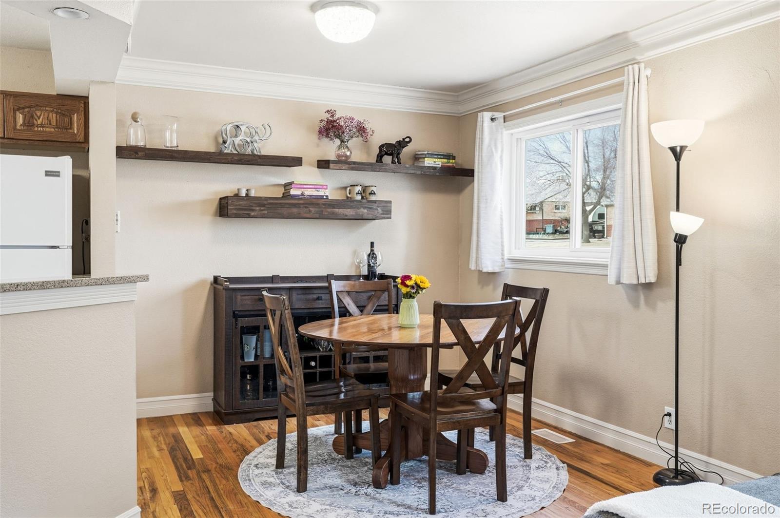 9280 Wigham Street Thornton, CO 80229 - Photo 8 of 34 a view of a dining room with furniture and chandelier