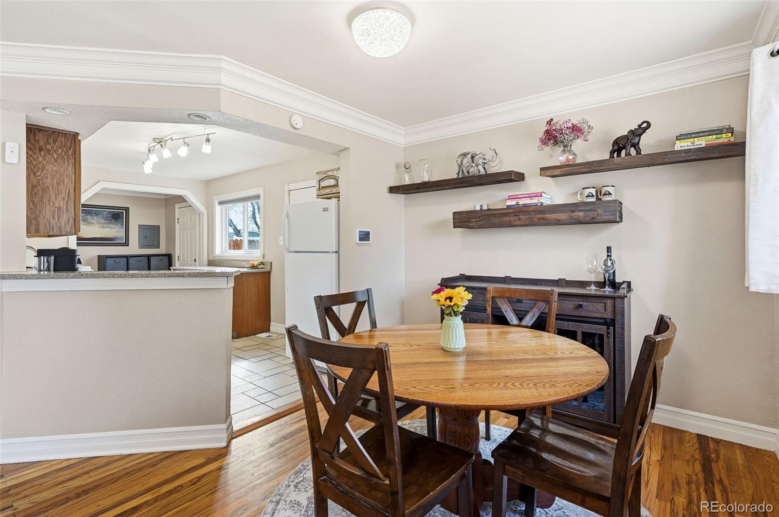 9280 Wigham Street Thornton, CO 80229 - Photo 9 of 34 a view of a dining room with furniture and wooden floor