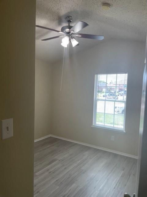 4753 Sea Ridge Drive Fort Worth, TX 76133 - Photo 16 of 16 an empty room with wooden floor fan and windows