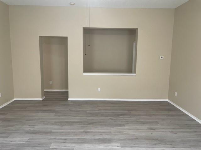 4753 Sea Ridge Drive Fort Worth, TX 76133 - Photo 6 of 16 a view of an empty room with wooden floor and a window