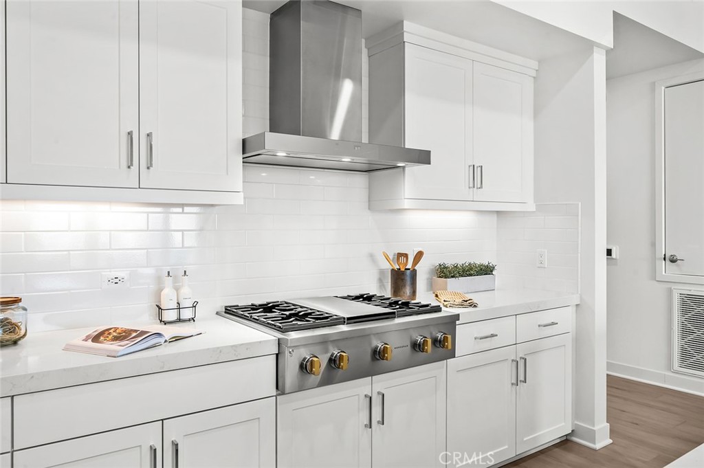 3604 Rivington Irvine, CA 92612 - Photo 10 of 54 a kitchen with white cabinets and appliances