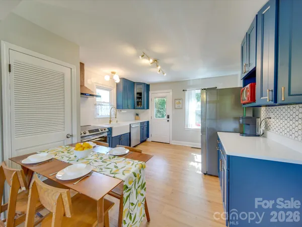 a view of a dining room with furniture and a kitchen