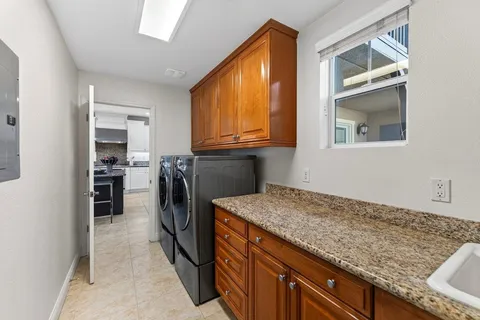 a kitchen with granite countertop cabinets and refrigerator