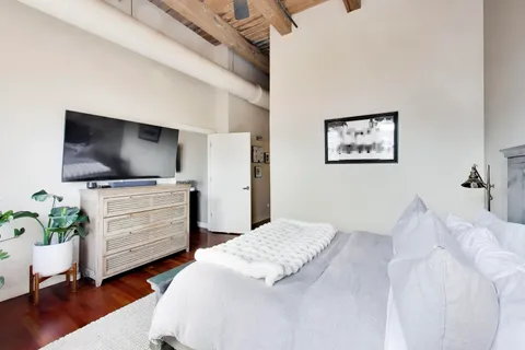 a bedroom with a bed and a flat screen tv