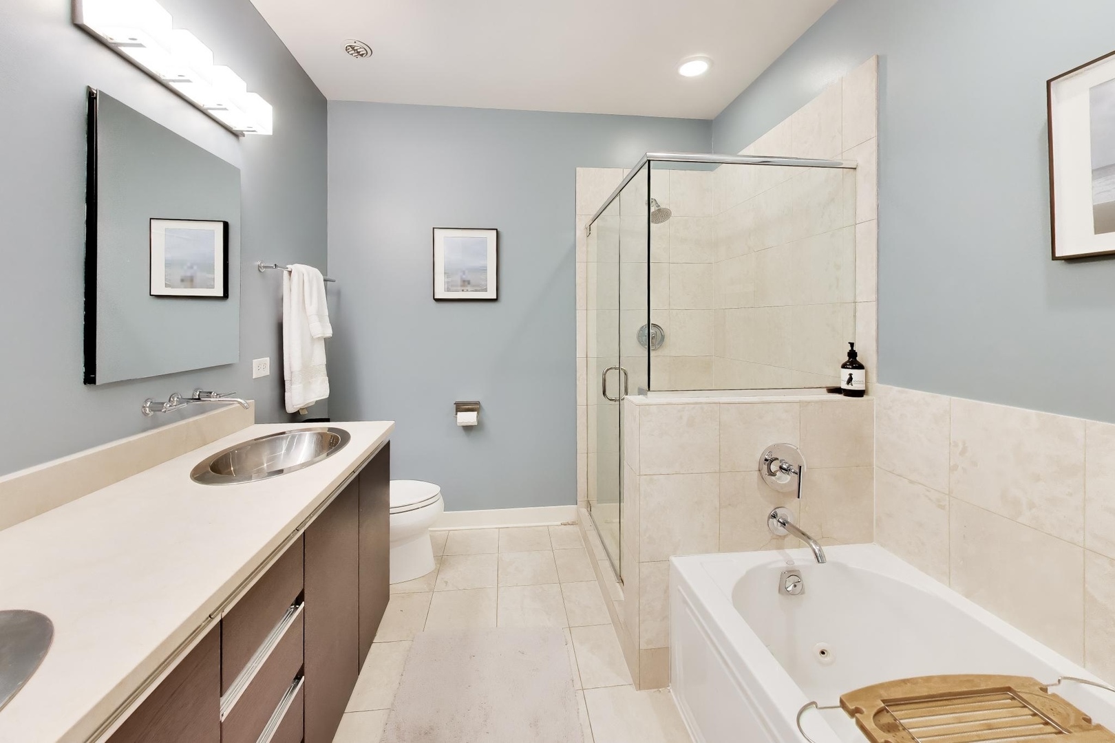 1050 West Hubbard Street, Unit 2F Chicago, IL 60642 - Photo 15 of 33 a bathroom with a tub sink and mirror