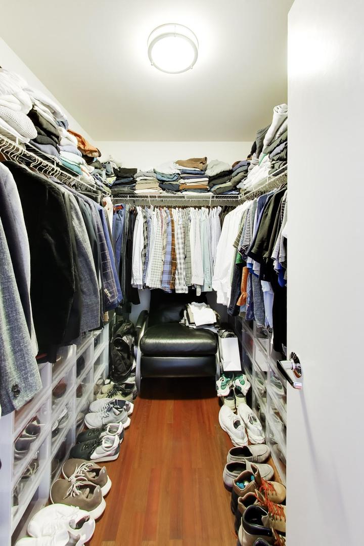 1050 West Hubbard Street, Unit 2F Chicago, IL 60642 - Photo 17 of 33 a view of walk in closet with clothes and shoes