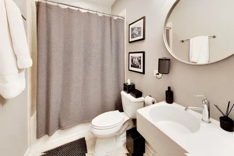 a bathroom with a toilet a sink and a mirror