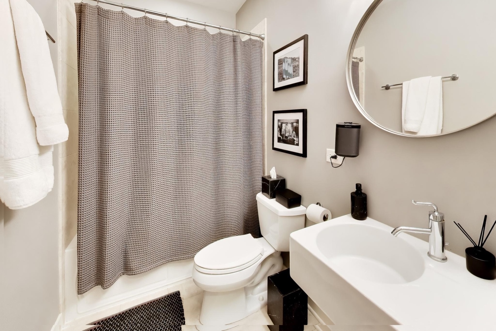 1050 West Hubbard Street, Unit 2F Chicago, IL 60642 - Photo 20 of 33 a bathroom with a toilet a sink and a mirror