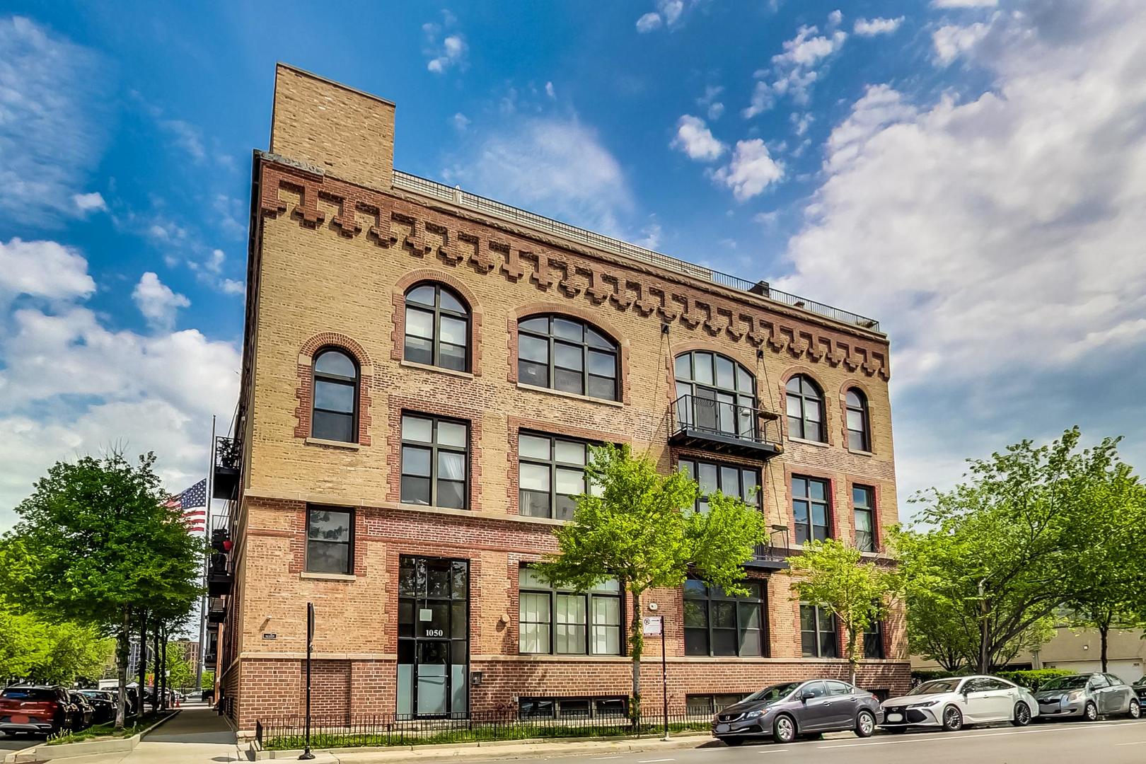 1050 West Hubbard Street, Unit 2F Chicago, IL 60642 - Photo 2 of 33 a front view of a building with lot of cars and trees