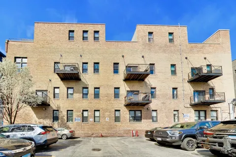 a couple of cars parked in front of a building