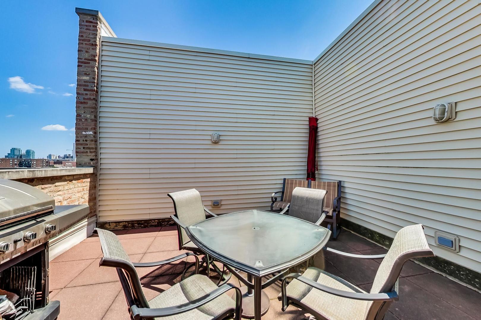 1050 West Hubbard Street, Unit 2F Chicago, IL 60642 - Photo 26 of 33 a view of a chairs and table in the balcony