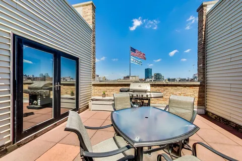 a view of a patio with a table and chairs