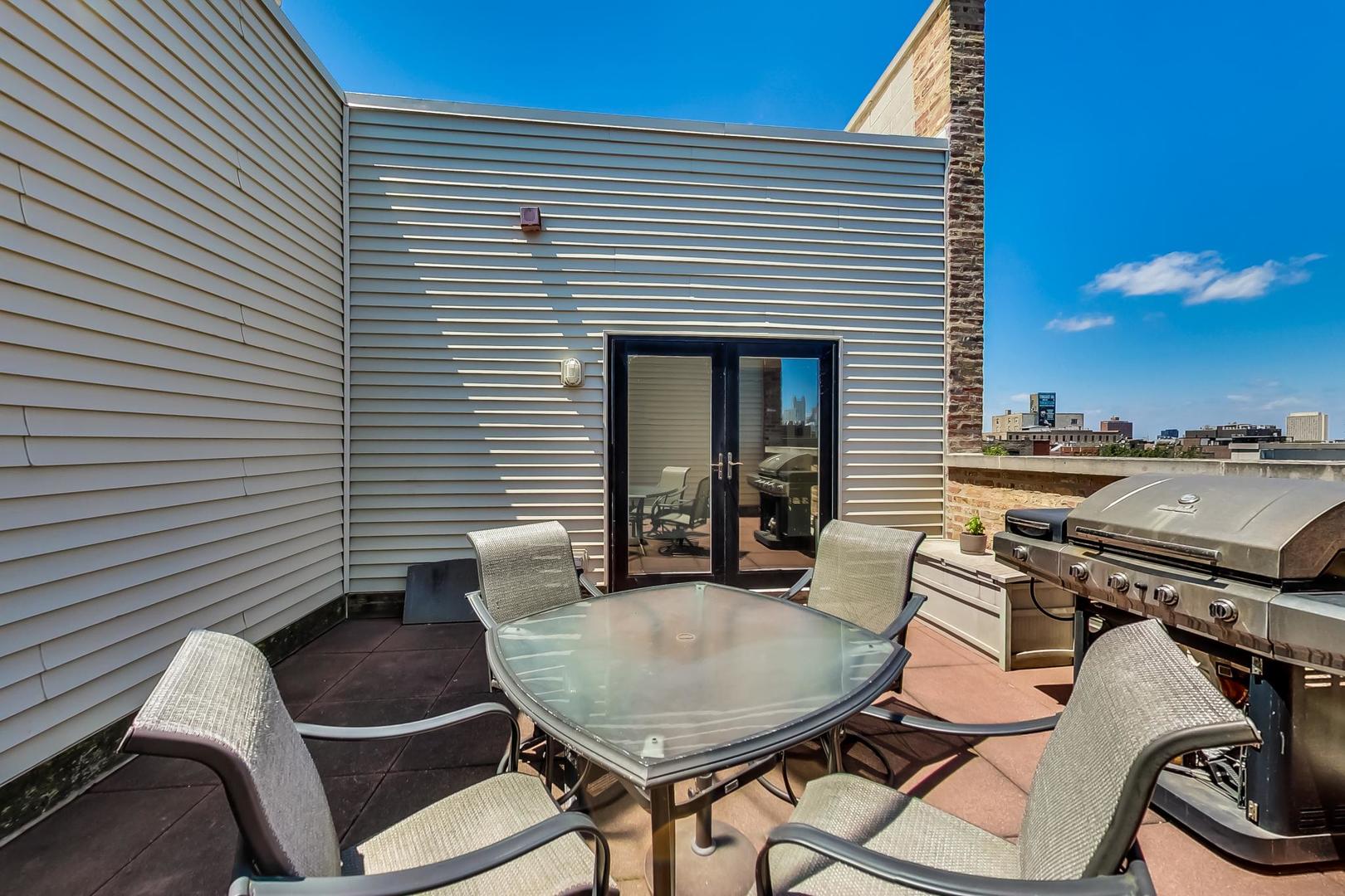 1050 West Hubbard Street, Unit 2F Chicago, IL 60642 - Photo 29 of 33 a view of a chairs and table in the balcony