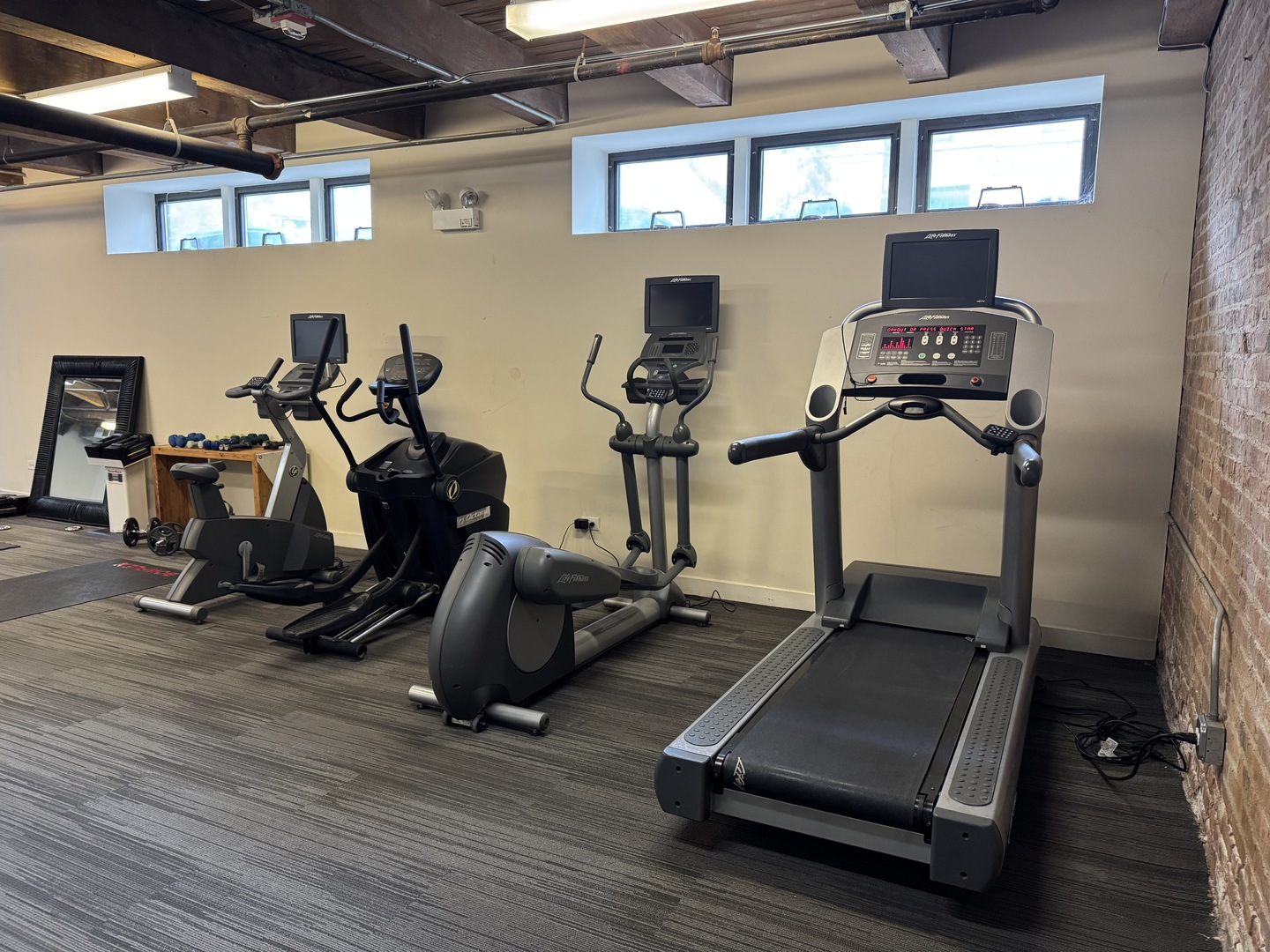 1050 West Hubbard Street, Unit 2F Chicago, IL 60642 - Photo 30 of 33 a room with gym equipment and wooden floor
