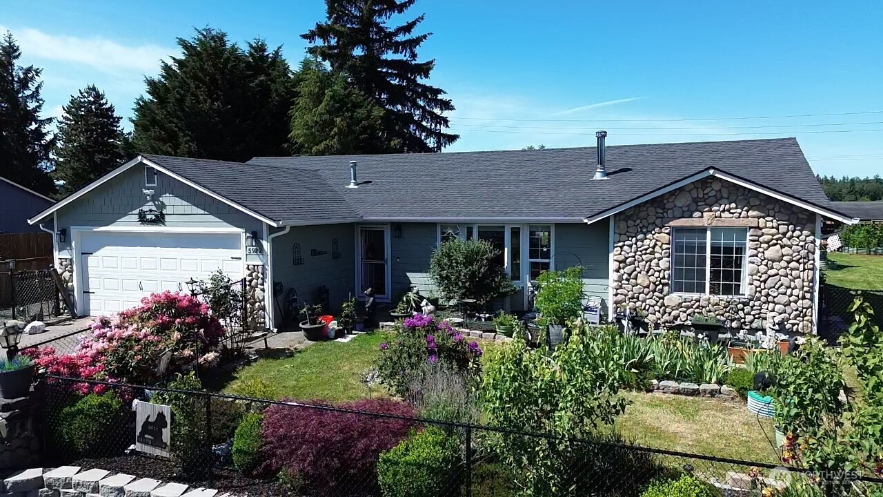 5922 184th Lane Southwest Rochester, WA 98579 - Photo 2 of 2 a front view of a house with a yard