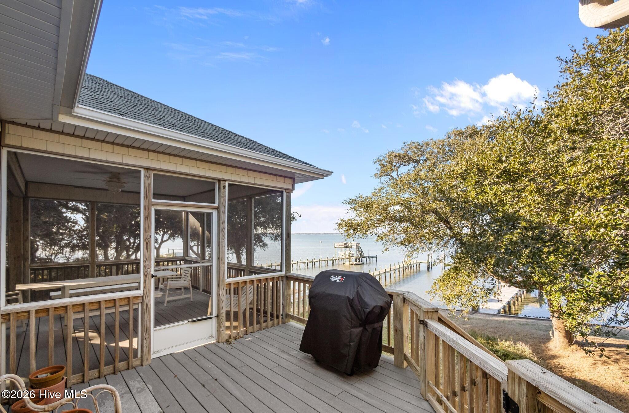 1206 Timber Trail Emerald Isle, NC 28594 - Photo 20 of 48 Grilling deck off screened porch overlooking back yard and pier