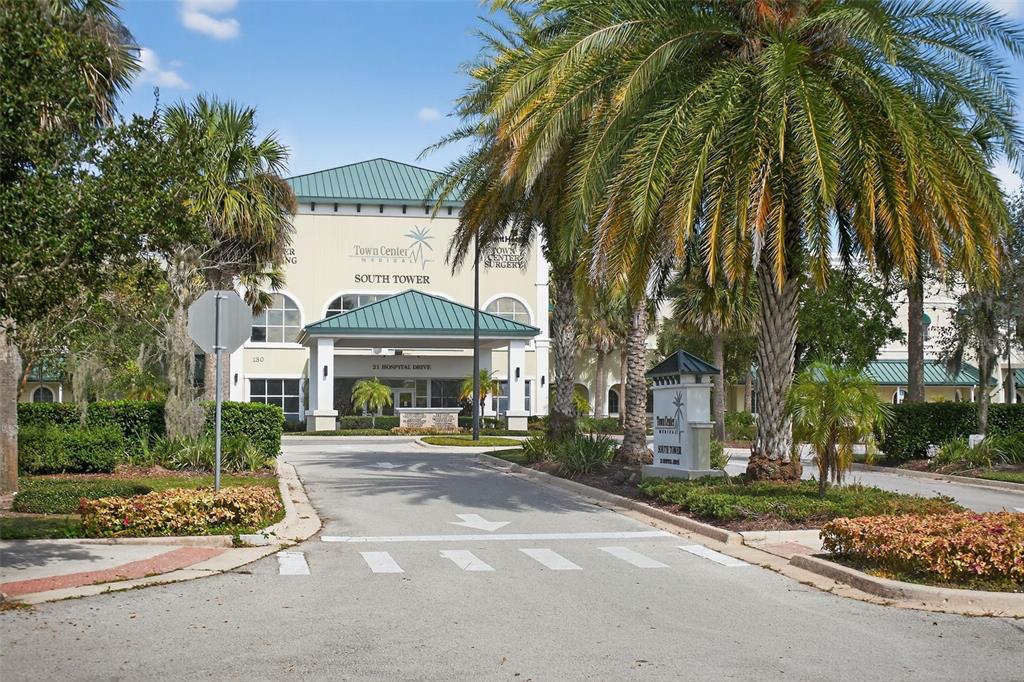 469 Bulldog Drive, Unit 3 Palm Coast, FL 32164 - Photo 12 of 54 a front view of a building with a garden and trees