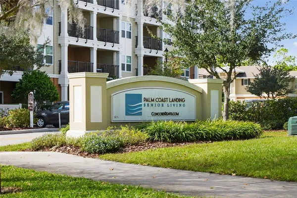a view of a deck with a big yard and large trees