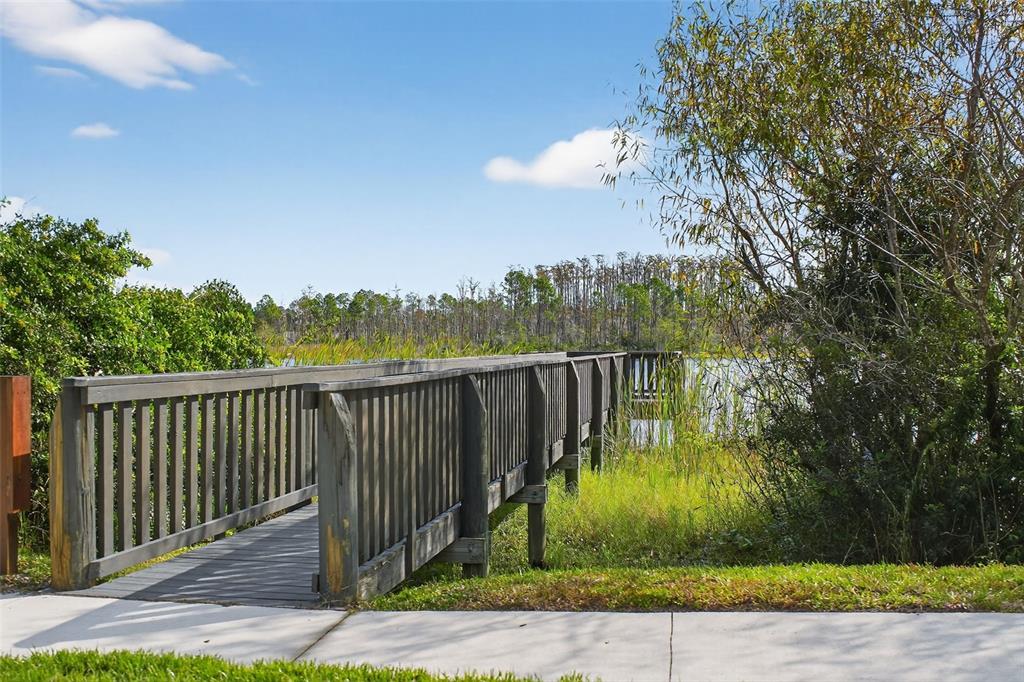 469 Bulldog Drive, Unit 3 Palm Coast, FL 32164 - Photo 32 of 54 a view of a deck with a big yard and large trees