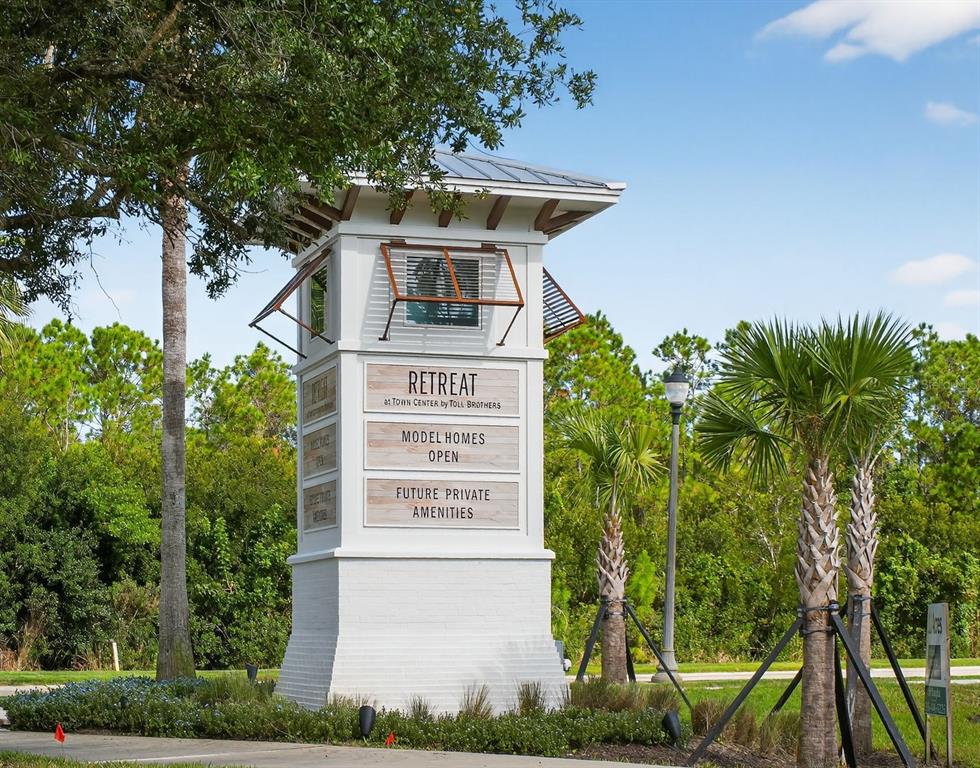 469 Bulldog Drive, Unit 3 Palm Coast, FL 32164 - Photo 40 of 54 a view of a tall building with a tree in the background