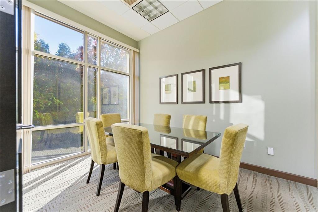 2626 Peachtree Road Northwest, Unit 1006 Atlanta, GA 30305 - Photo 13 of 19 a view of a dining room with furniture a rug and wooden floor