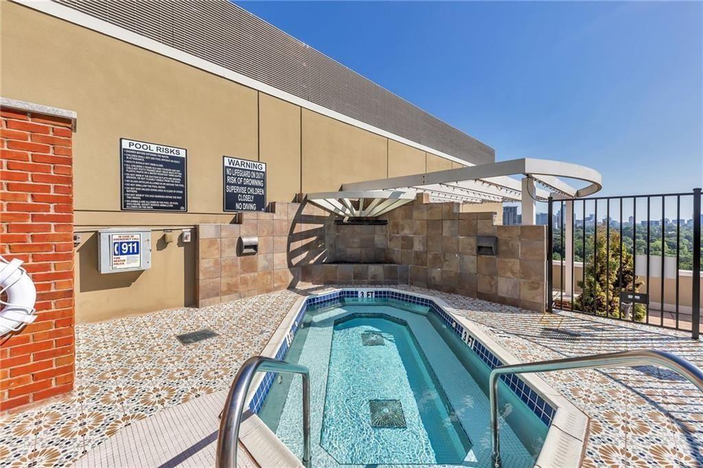 2626 Peachtree Road Northwest, Unit 1006 Atlanta, GA 30305 - Photo 19 of 19 a bedroom with a bed and a painting on the wall