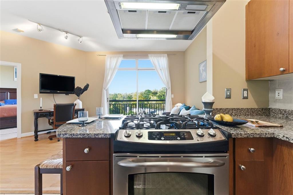 2626 Peachtree Road Northwest, Unit 1006 Atlanta, GA 30305 - Photo 8 of 19 a kitchen with a stove a sink and a microwave